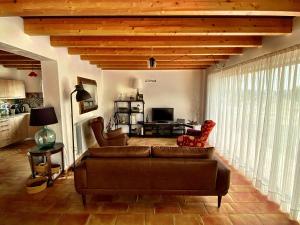 a living room with a couch and a television at Cortijo Jamaro Boutique in Cehegín