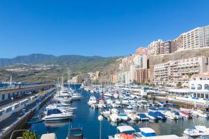 a group of boats docked in a harbor with buildings at Radazul Marina Seafront 12 in Radazul