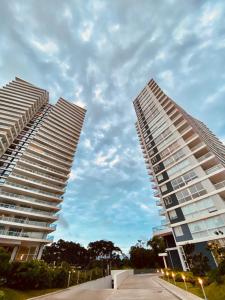 two tall white buildings next to each other at Torre One II Punta Del Este in Punta del Este