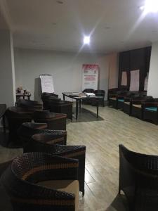 a room with a bunch of chairs and tables at Hotel Lazi in K'obulet'i