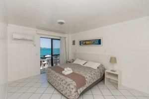Ein Bett oder Betten in einem Zimmer der Unterkunft Bombinhas Tourist Apart