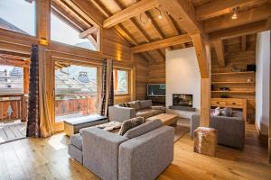 a living room with two couches and a tv at Chalet 1155 - Montroc - Chamonix in Chamonix-Mont-Blanc