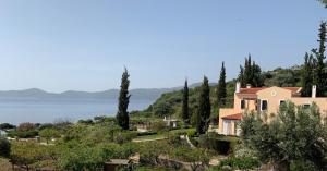 a house on a hill with a view of the water at Oneiro in Vathírrevma