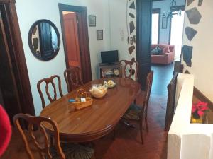 a dining room with a wooden table and chairs at Canarian House with views and pool in Los Realejos