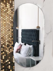 a mirror in a room with a couch and pillows at Bahar Boutique Hotel in Thessaloniki