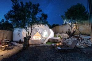 a iguana house in a yard at night at Balloon Suites with Sky View in Nea Moudania
