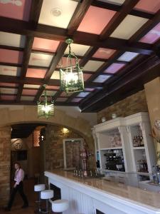 a man walks past a bar in a restaurant at Hotel Juan Carlos I in Villarrobledo