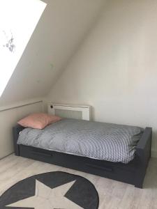 a bedroom with a bed in a attic at Tastefull double story 2 bedroom appartment/house in Haarlem