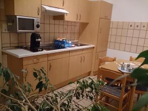 a small kitchen with a sink and a table at Villa Hebel in Cuxhaven