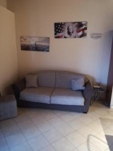 a living room with a couch and two pictures on the wall at Casa Lorena in Desenzano del Garda
