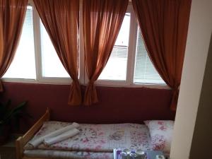 a bedroom with a bed in front of a window at Guest house Mirijevski Konak in Belgrade
