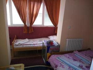 a small room with two beds and a window at Guest house Mirijevski Konak in Belgrade