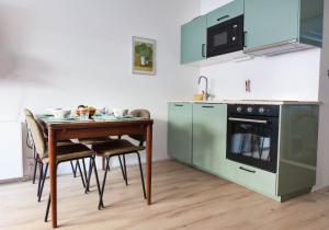a kitchen with a table with chairs and a stove at Shortstay Scheveningen in Scheveningen