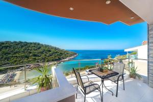 a balcony with a view of the ocean at Villa Irene in Skala Marion