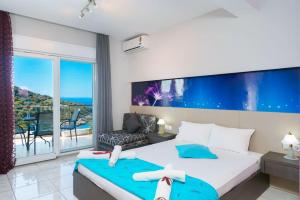 a bedroom with a bed and a view of the ocean at Villa Irene in Skala Marion