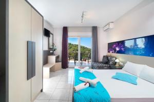a bedroom with a large bed and a couch at Villa Irene in Skala Marion