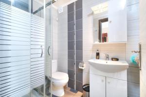 a bathroom with a toilet and a sink at Villa Irene in Skala Marion +49 photos