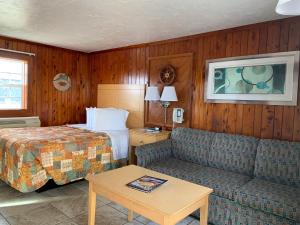 ein Hotelzimmer mit einem Bett und einer Couch in der Unterkunft Sea Horse Inn and Cottages in Nags Head