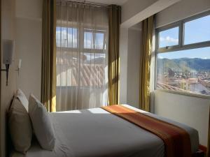 Un pat sau paturi într-o cameră la Hotel Sueños del Inka