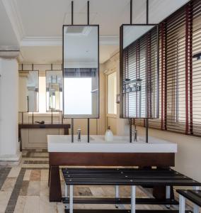 a bathroom with a sink and a mirror at Porto Romano - The Marina Resort in Fiumicino