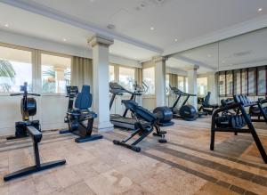 a gym with several treadmills and exercise machines at Porto Romano - The Marina Resort in Fiumicino