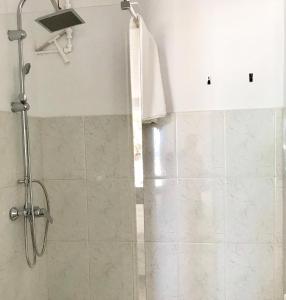 a bathroom with a shower with a glass door at Tejita Seaview Apartment in El Médano