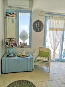 a living room with a chair and a table at Le Terrazze in Otranto