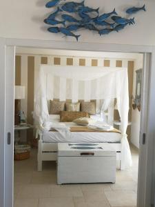 a bedroom with a white bed with a white canopy at Le Terrazze in Otranto
