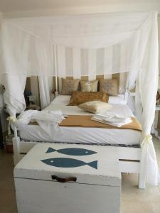 a bedroom with a white bed with a canopy at Le Terrazze in Otranto