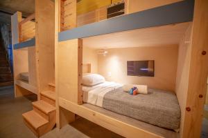 a bedroom with a bunk bed and a tv at PodShare San Diego in San Diego