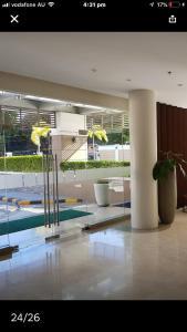 a lobby with a pool and a potted plant at Fantastic Affordable high end condominium heart of the Cebu city in Cebu City