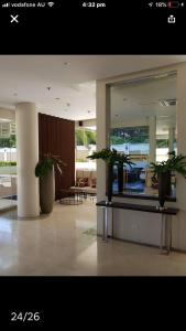 a lobby with two potted plants in a building at Fantastic Affordable high end condominium heart of the Cebu city in Cebu City +56 photos