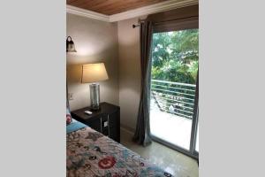 a bedroom with a bed and a sliding glass door at Havensight Haven 1BR/1.5BA in Estate Thomas