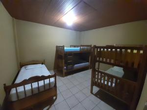 a room with three bunk beds in a room at Las Casitas Hostal-Ataco in Concepción de Ataco