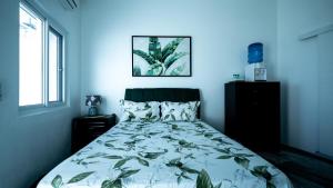 a bedroom with a bed with a blue background at Pacific View Dalaguete in Dalaguete +55 photos