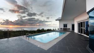 a swimming pool on the balcony of a house at Pacific View Dalaguete in Dalaguete