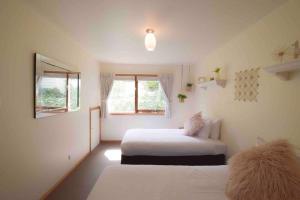 a bedroom with two beds and a window at Best Location in Hobart! Luxury 4 bedroom with stunning views in Hobart