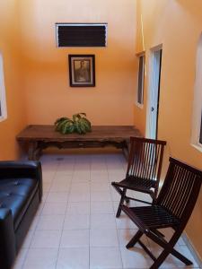 a living room with a table and two chairs at Bungalows Princeza Guayabitos in Rincon de Guayabitos