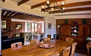 a dining room with a wooden table and chairs at Hostería Canela B&B in Esquel