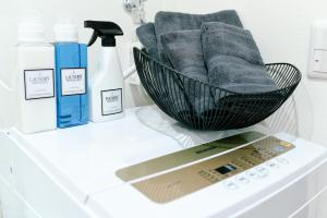 a bathroom counter with a sink with a basket of towels at Sou in Fujisawa
