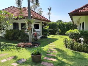 a yard of a house with a garden at Smile House & Pool in Rawai Beach
