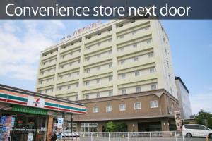 a large building with the texturance store next door at Hotel nanvan Yaizu in Yaizu