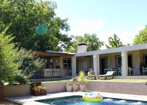 a house with a pool in front of it at Nuwerus Lodge Paarl in Paarl