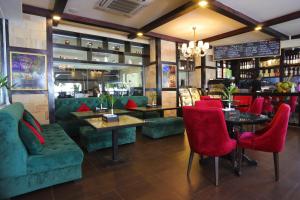 a restaurant with red chairs and tables and a bar at Queenco Entertainment Resort in Sihanoukville