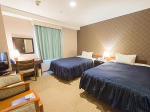 Säng eller sängar i ett rum på Shizunai Eclipse Hotel