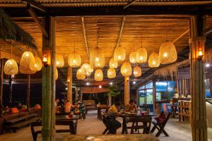 un restaurante con un montón de luces colgando del techo en The Cosy Koh Phangan and Restaurant, en Thong Sala