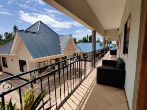 a balcony of a house with a black railing at Wanyama B&B in Arusha