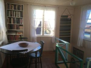 
a dining room table with chairs and a window at Brunnsta Gård in Bålsta
