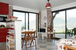 a kitchen and living room with a table and chairs at T2 Balcon de l'Embrunais in Saint-Sauveur