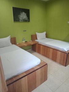 Postel nebo postele na pokoji v ubytování Orange Hotel